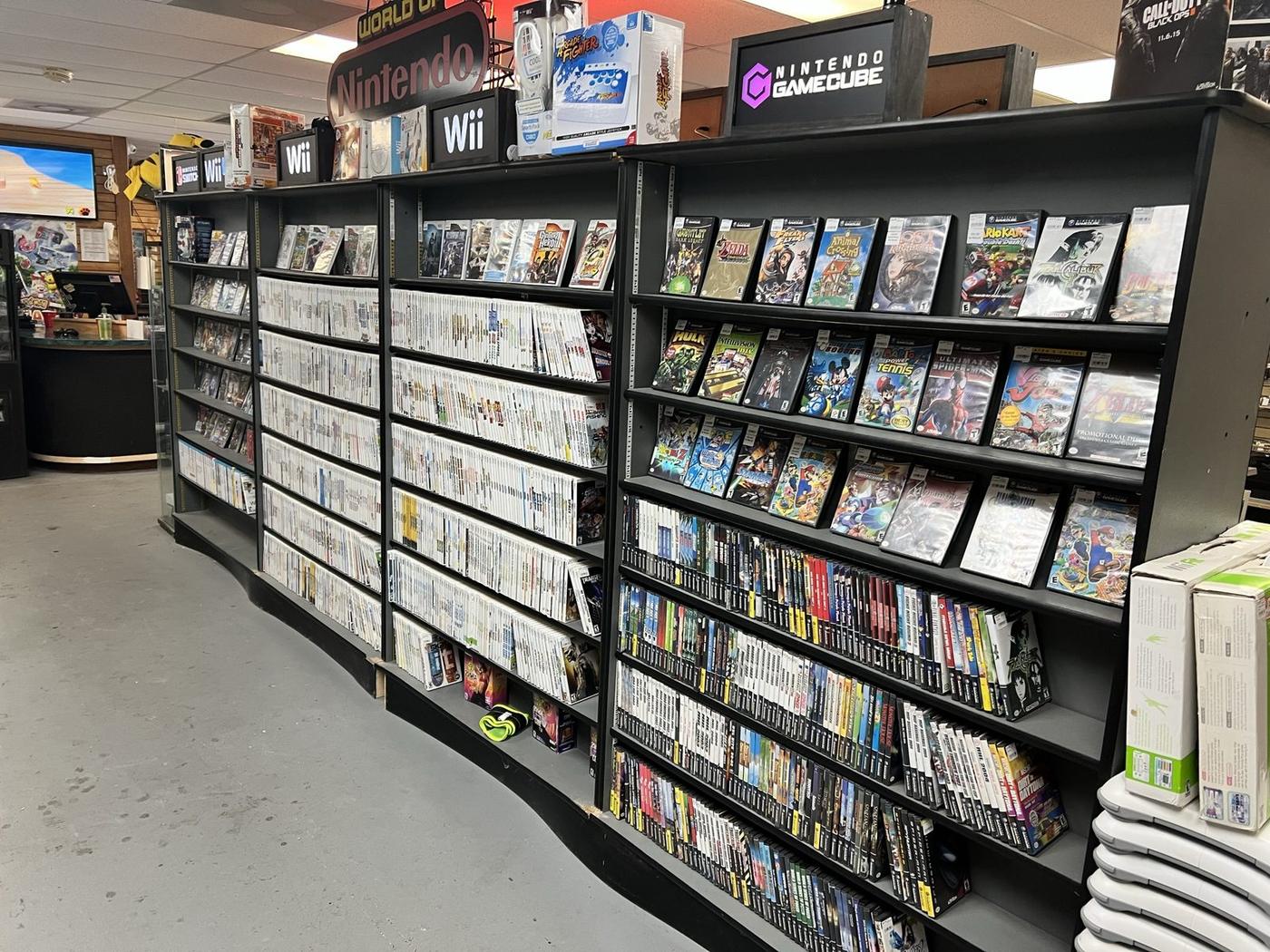 Long aisle of disc games sorted by system