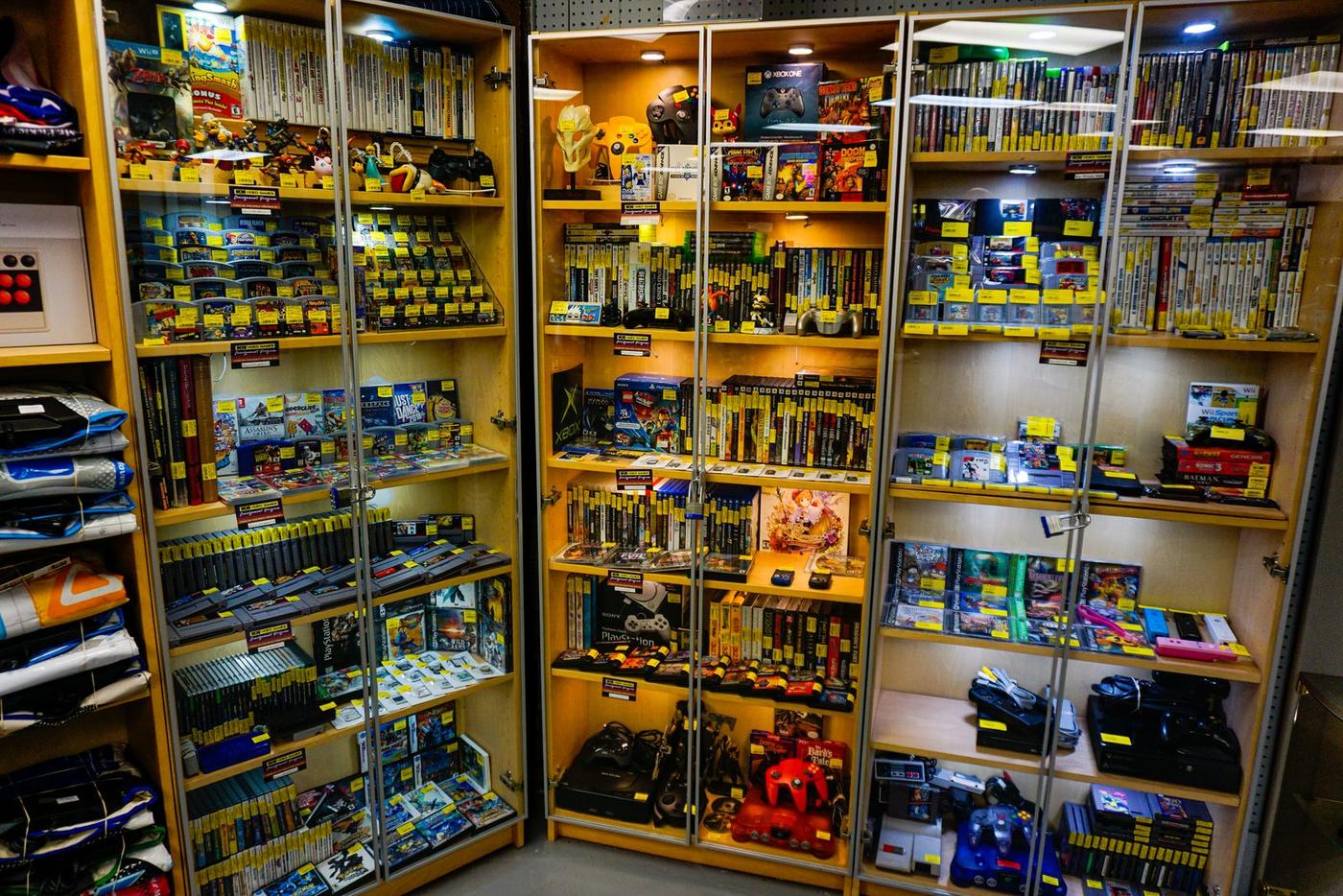 Glass case full of retro consoles and handhelds